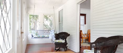 Leaded glass windows wrap around front porch