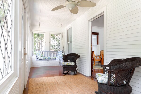 Leaded glass windows wrap around front porch