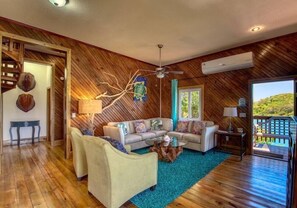 Nicely decorated living area with TV and AC