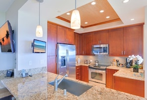 The high-end kitchen features all stainless steel appliances and ocean views from your work space