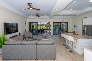 View of the living room, kitchen and dining room when entering the home