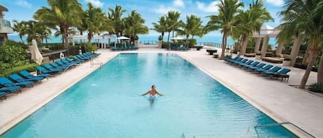 Upper pool with lush landscaping, a tropical oasis.