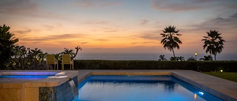 Night view of pool and spa