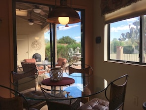 Amazing view from eat-in kitchen area to a covered patio with ceiling fans.