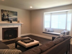 Cozy living room with lovely window seat for relaxing and fun conversation.