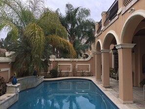 view of the front entrance of the house overlooking the pool and courtyard. 