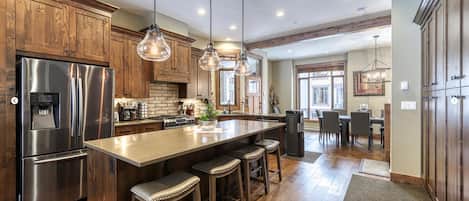 Kitchen with stainless steel appliances, island seating for four