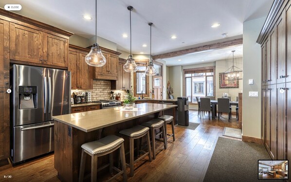 Kitchen with stainless steel appliances, island seating for four