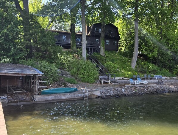 Front view of property - dock at left, beach in foreground, house up top