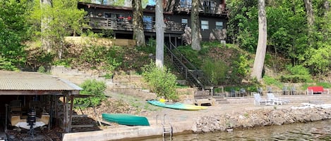 House and two-tiered beach from dock, with canoe, kayaks & swim ladder