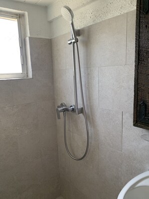 Renovated bathroom with hot water and new ceramic tiles