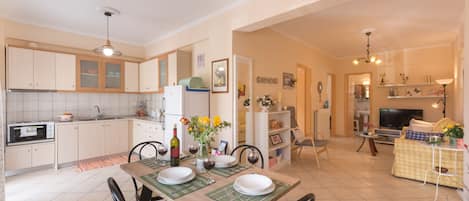 Wide view of kitchen, dining area and living room.