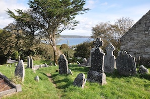 Ardmore - the view over the grave stones of the old church and over the cliffs