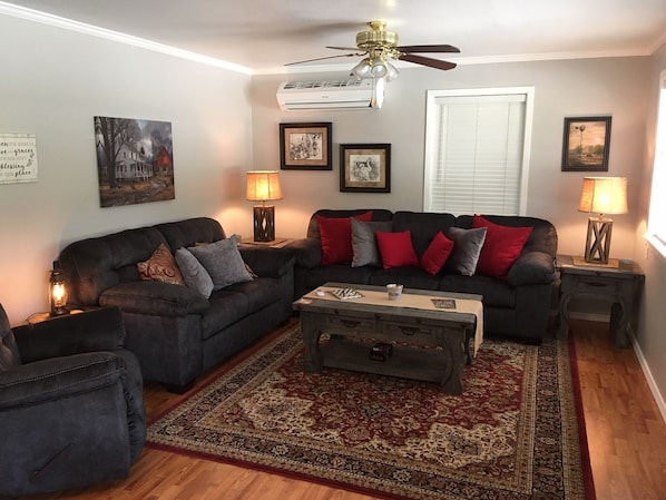 A cozy modern living room with comfy seating for up to five people.