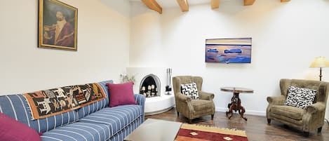 Living room with wood burning kiva fireplace