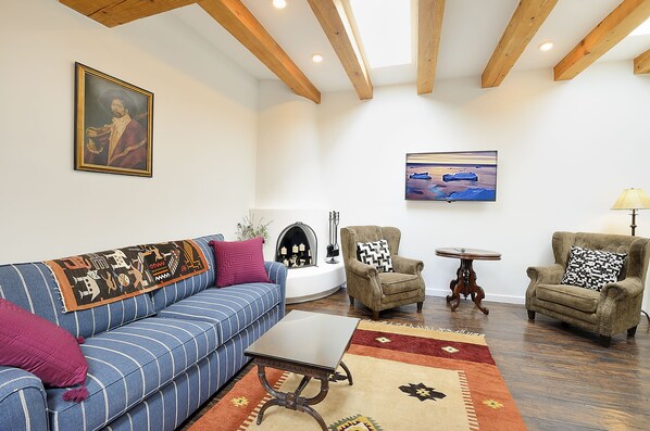 Living room with wood burning kiva fireplace