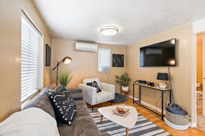 Unwind on this cozy couch as the living room fills with natural light.