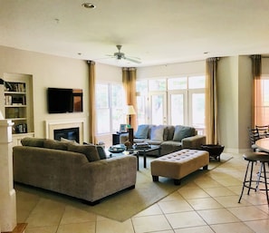 Open concept family room/kitchen combo with French doors leading to Dining Porch