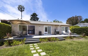 Front yard deck and BBQ invites guests to enjoy a meal outside or soak up the sun on the patio loungers