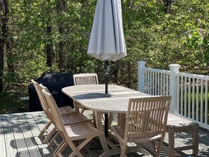 New teak outdoor furniture with large Napoleon grill.  
