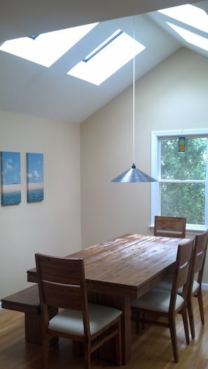 Vaulted ceiling dining room with 4 skylights and rustic farm table