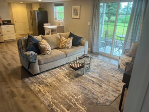 Open kitchen & living room with a patio just outside the sliding glass doors.  
