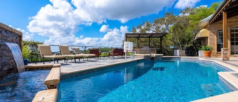 The pool also contains a waterfall and basketball hoop.