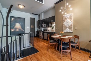 Open kitchen, dining room, spiral staircase to downstairs bedroom.