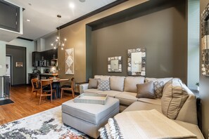 View of open space of living room, dining area and kitchen