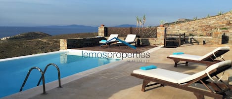 Large terrace with sunbathing areas and seating arreas