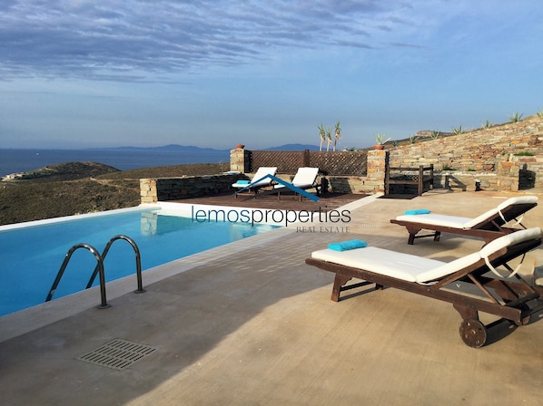 Large terrace with sunbathing areas and seating arreas