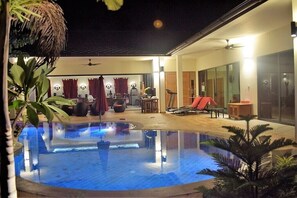 Villa and pool at night