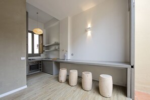 The kitchen corner and and the internal dining table with the closed wall-table.