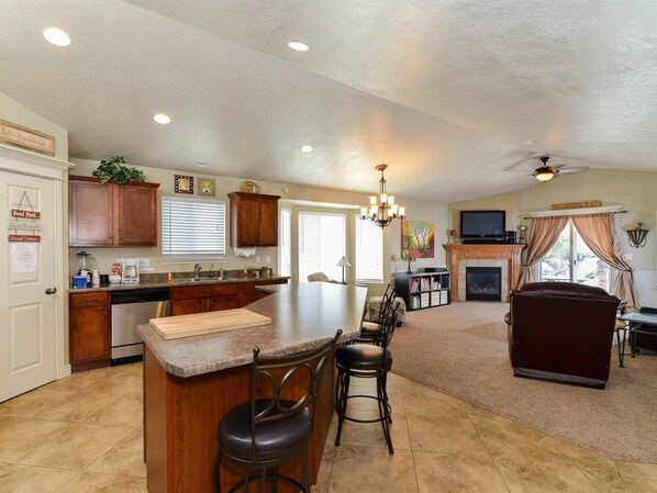 FAMILY ROOM OFF KITCHEN WITH SOFA, RECLINER, GAS FIREPLACE, FLATSCREEN TV