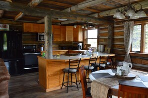 Modern kitchen with new appliances and hand-made cabinetry.