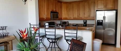 Open kitchen with granite counter tops and stainless steel appliances