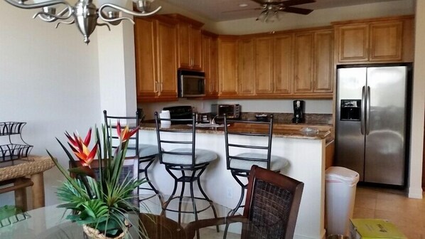 Open kitchen with granite counter tops and stainless steel appliances