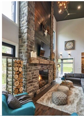 Grand family room and stone fireplace with salvaged barn beam mantle 