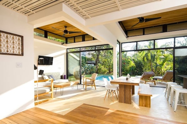 Spacious and sunny! This living and dining room area has glass doors that fully open to the pool deck so you can enjoy the indoor/outdoor living of Nosara! 