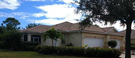 Front of villa with attached car and a 1/4 (golf car) garage