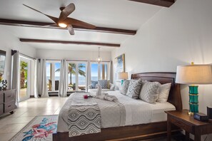 Master bedroom (1st floor) features en suite bath, TV, A/C, doors to patio/pool