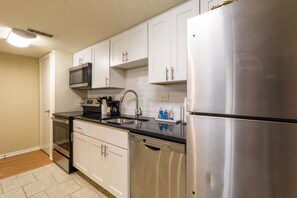 Kitchen with all appliances and supplies,