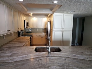 Fully equipped kitchen with granite countertops and full sized appliances