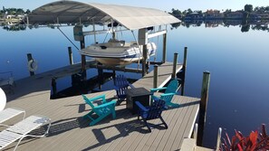 Private boat and dock with gas fire table.  Easily get boat into water with lift