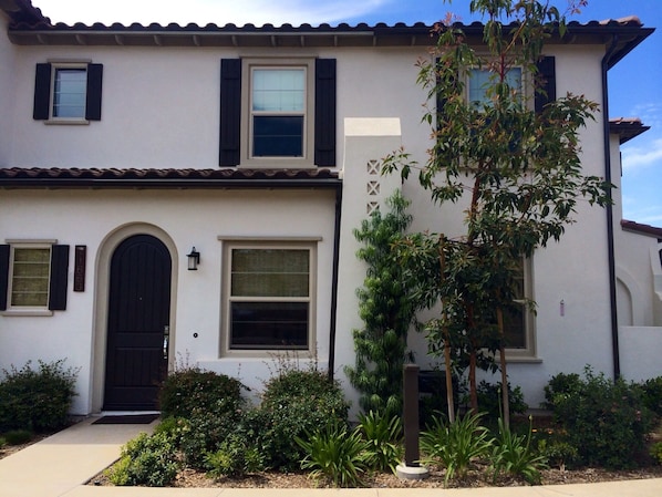 Front Door open to Shared Lawn and Playscape