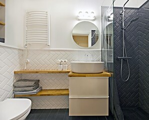 Bathroom. Sparkling clean and equipped with a shower.