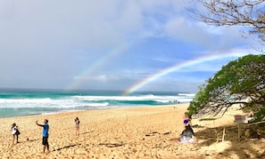double rainbow on beach in front of the house
