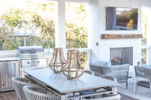 Full Outdoor Kitchen with Gas Grill, Mini-Fridge, and Prep space.