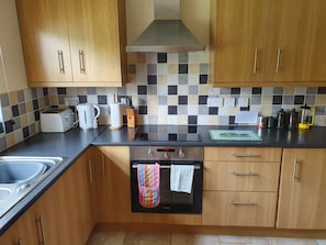 Fully fitted kitchen with oven, hob, dishwasher, fridge and freezer