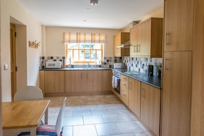 Fully fitted kitchen with oven, hob, dishwasher, fridge and freezer